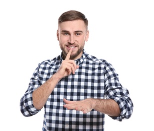 Man showing HUSH gesture in sign language on white background