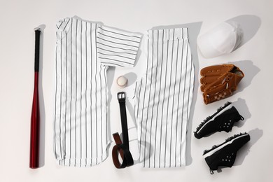 Photo of Flat lay composition with baseball uniform on white background