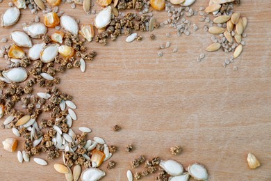 Photo of Different vegetable seeds on wooden table, flat lay. Space for text
