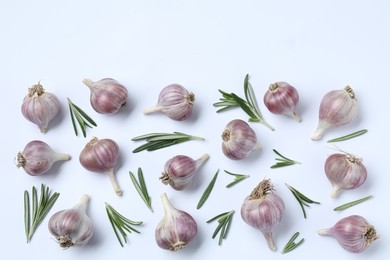 Photo of Fresh garlic and rosemary on white background, flat lay. Space for text