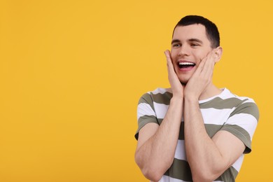 Photo of Portrait of surprised man on orange background, space for text