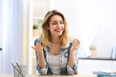 Photo of Beautiful woman using video chat for conversation indoors