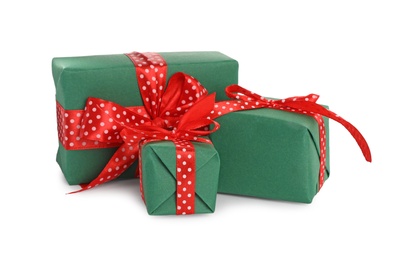Photo of Christmas gift boxes decorated with red bows on white background