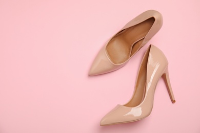 Photo of Pair of beautiful shoes and space for text on color background, top view