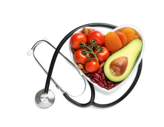 Photo of Heart shaped bowl with healthy products and stethoscope on white background, top view