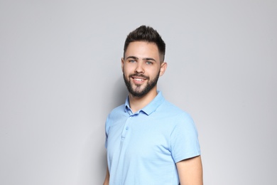 Photo of Portrait of handsome young man against light background