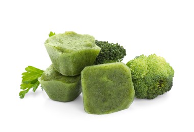 Photo of Frozen broccoli puree cubes and fresh broccoli isolated on white