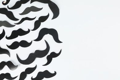 Photo of Fake paper mustaches on light background, flat lay. Space for text