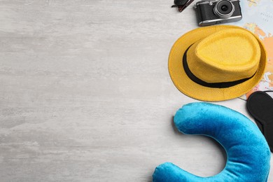 Flat lay composition with blue travel pillow on light background, space for text