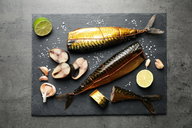 Photo of Tasty smoked fish on grey table, top view