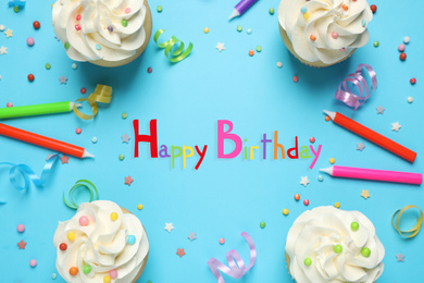 Image of Flat lay composition with cupcakes on light blue background. Happy Birthday