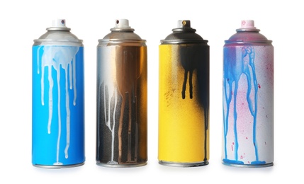 Photo of Used cans of spray paint on white background