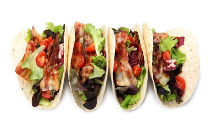Photo of Delicious tacos with fried bacon and tomatoes on white background, above view