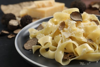 Photo of Tasty tagliatelle with truffle on table, closeup