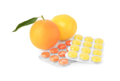 Photo of Fresh fruits and blisters with cough drops isolated on white
