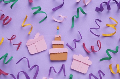Photo of Birthday party. Paper cake, gifts and confetti on lilac background, flat lay