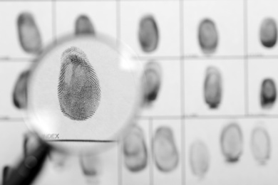 Photo of Criminal fingerprint card and magnifier, top view. Space for text