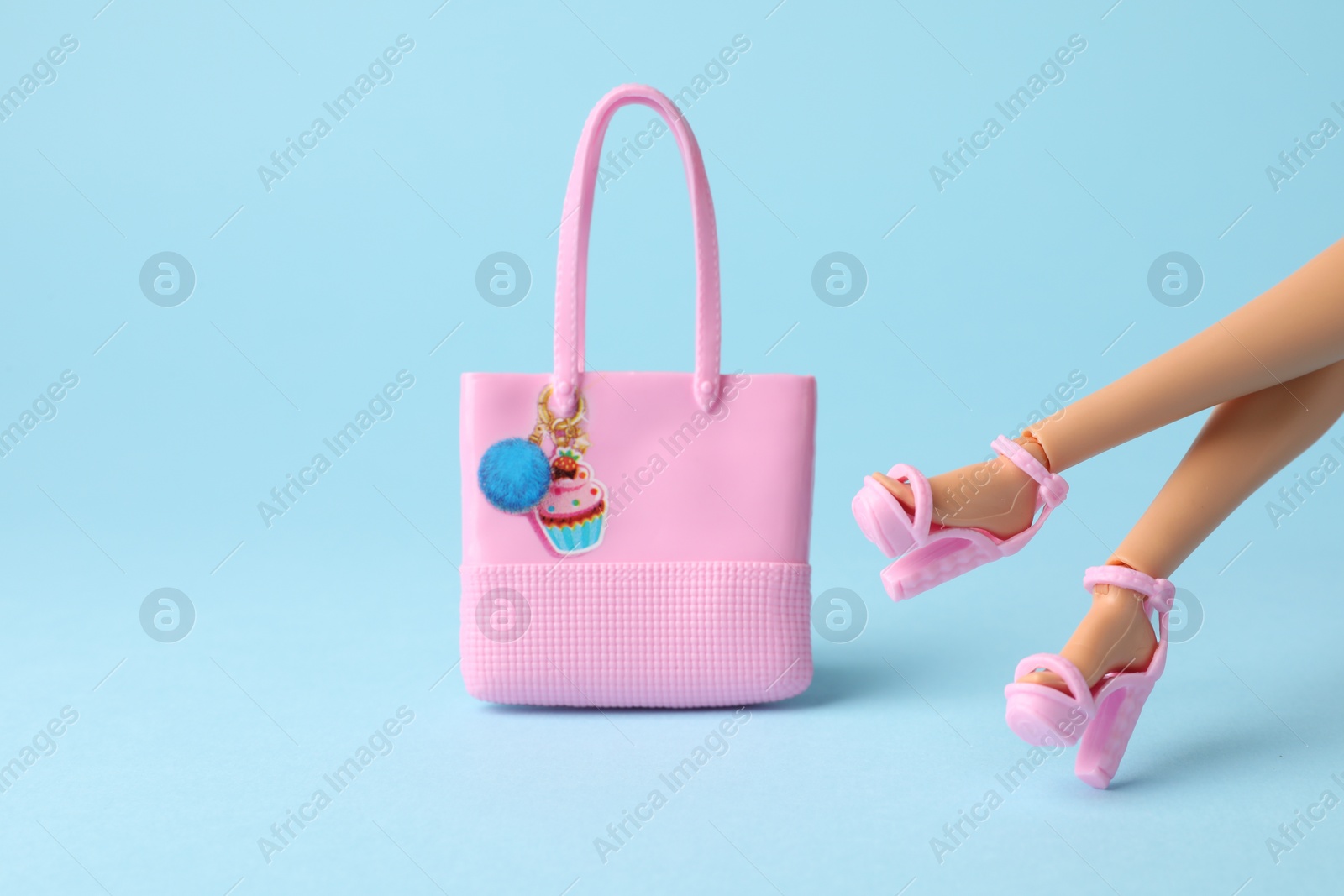 Photo of Mykolaiv, Ukraine - September 4, 2023: Barbie doll in beautiful heels and bag on light blue background, closeup