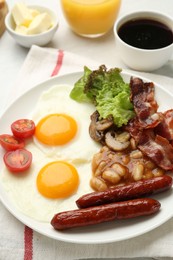 Photo of Delicious breakfast with sunny side up eggs on white table, closeup