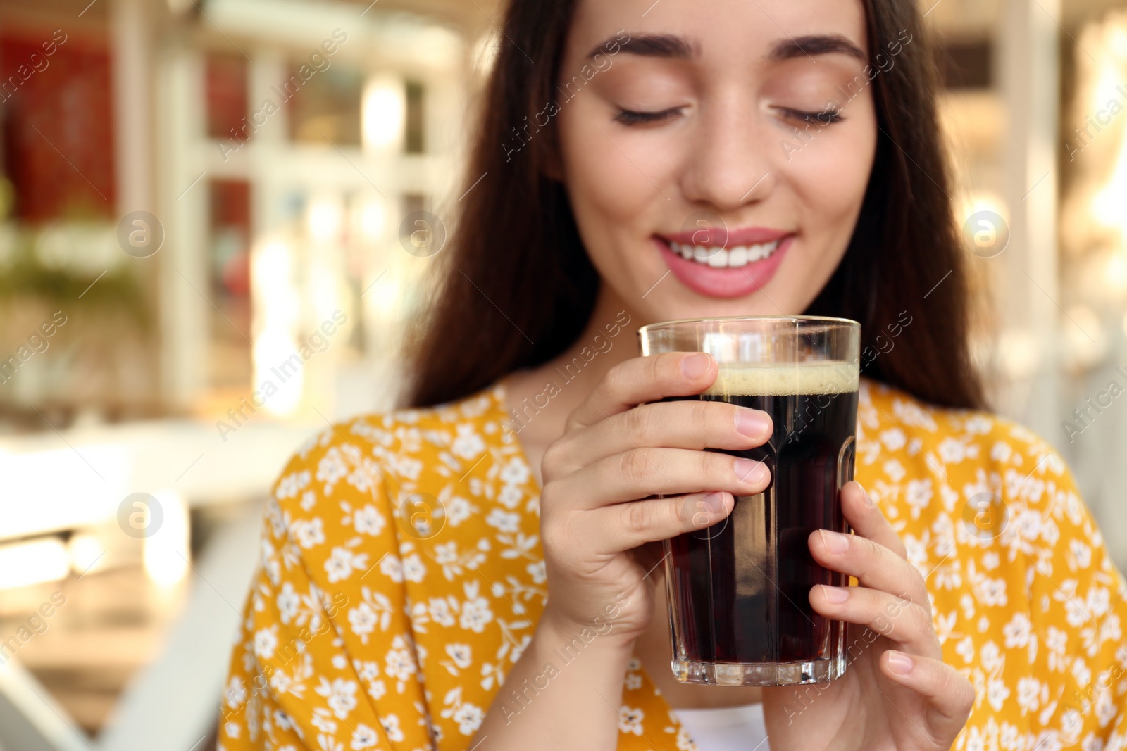 Photo of Beautiful woman with cold kvass outdoors. Traditional Russian summer drink