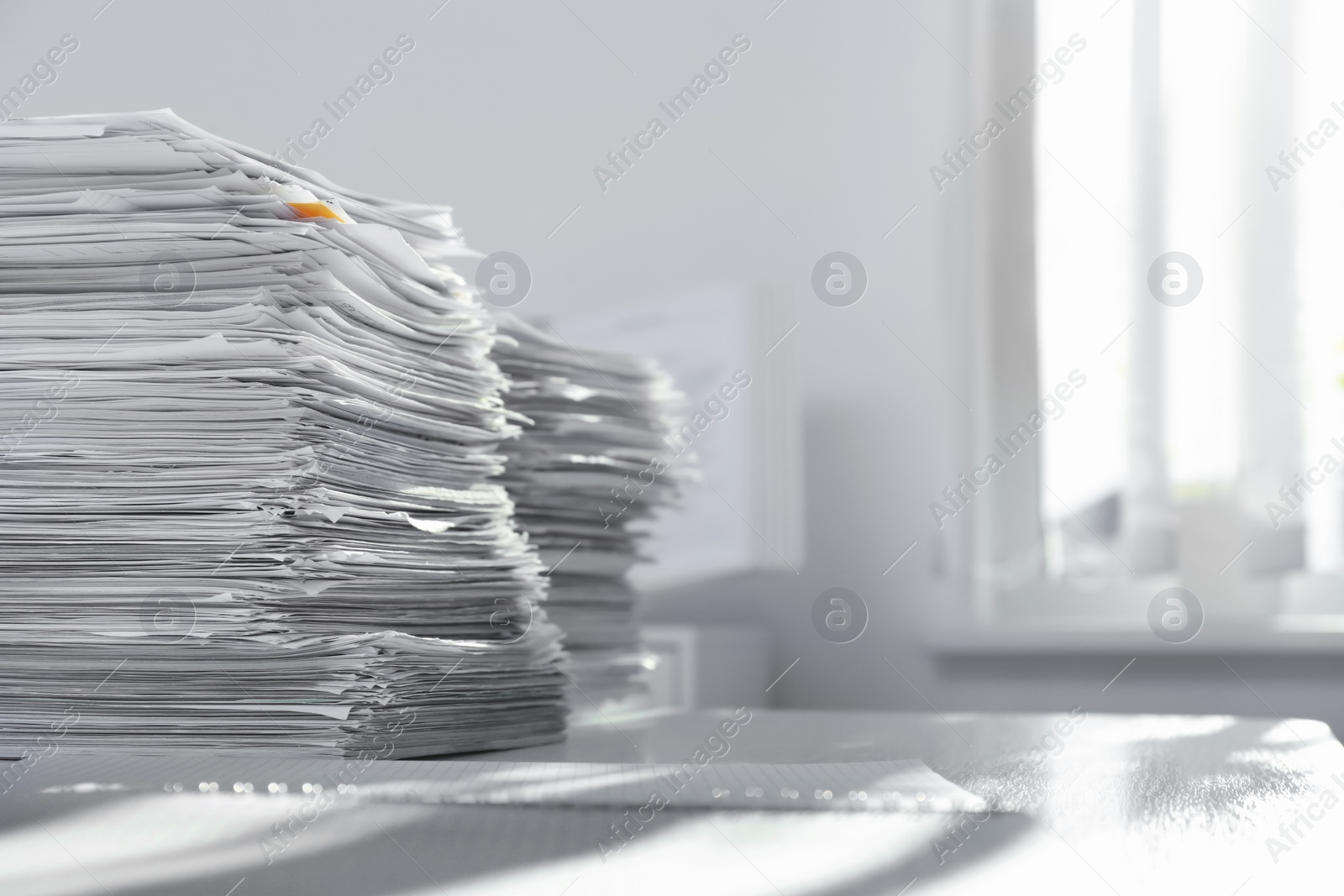 Photo of Stacks of documents on table in office. Space for text