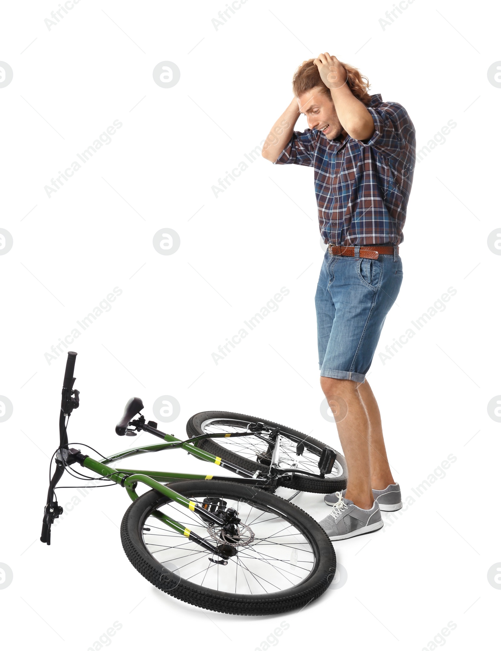 Photo of Emotional young man with bicycle on white background