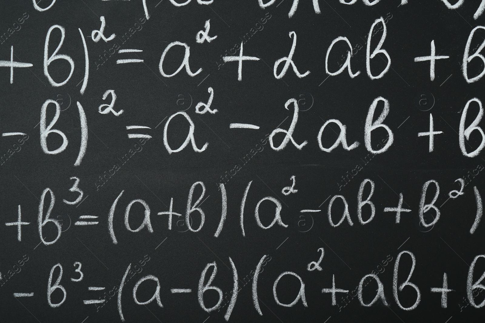 Photo of Many different math formulas written on chalkboard, closeup