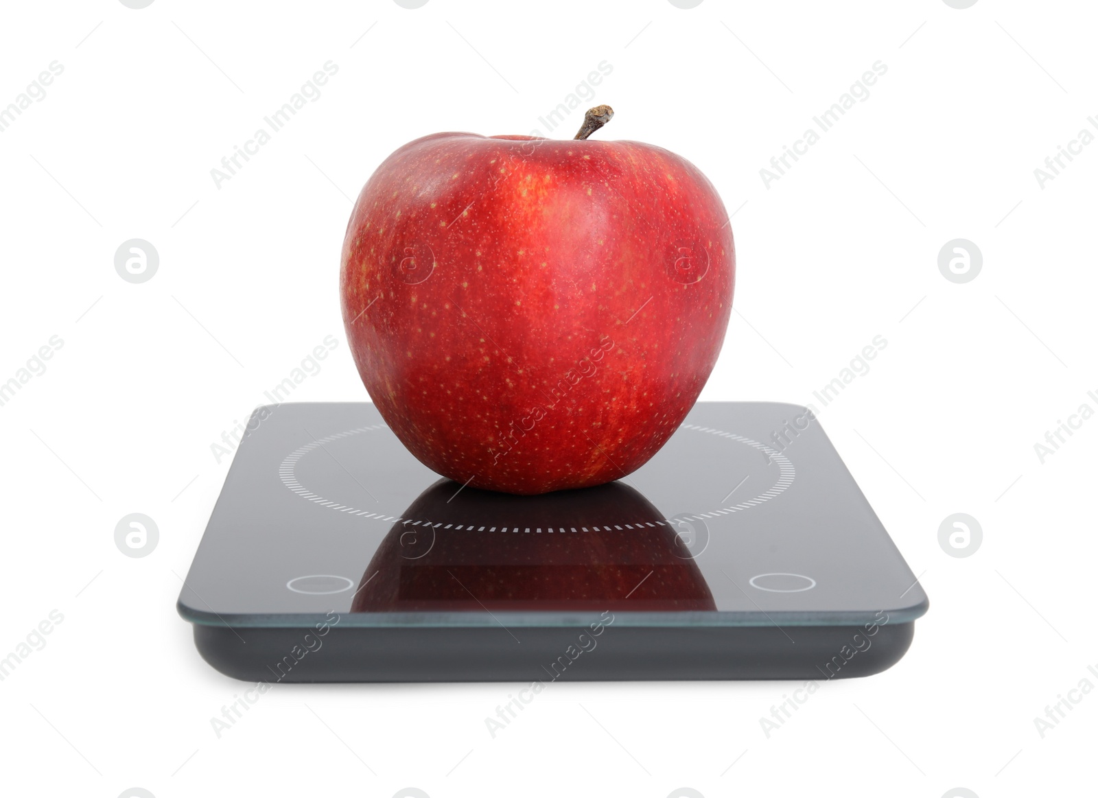 Photo of Ripe red apple and electronic scales on white background