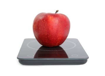 Ripe red apple and electronic scales on white background