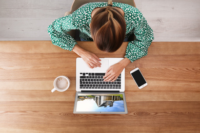 Woman choosing new house online using laptop or real estate agent working at table, top view