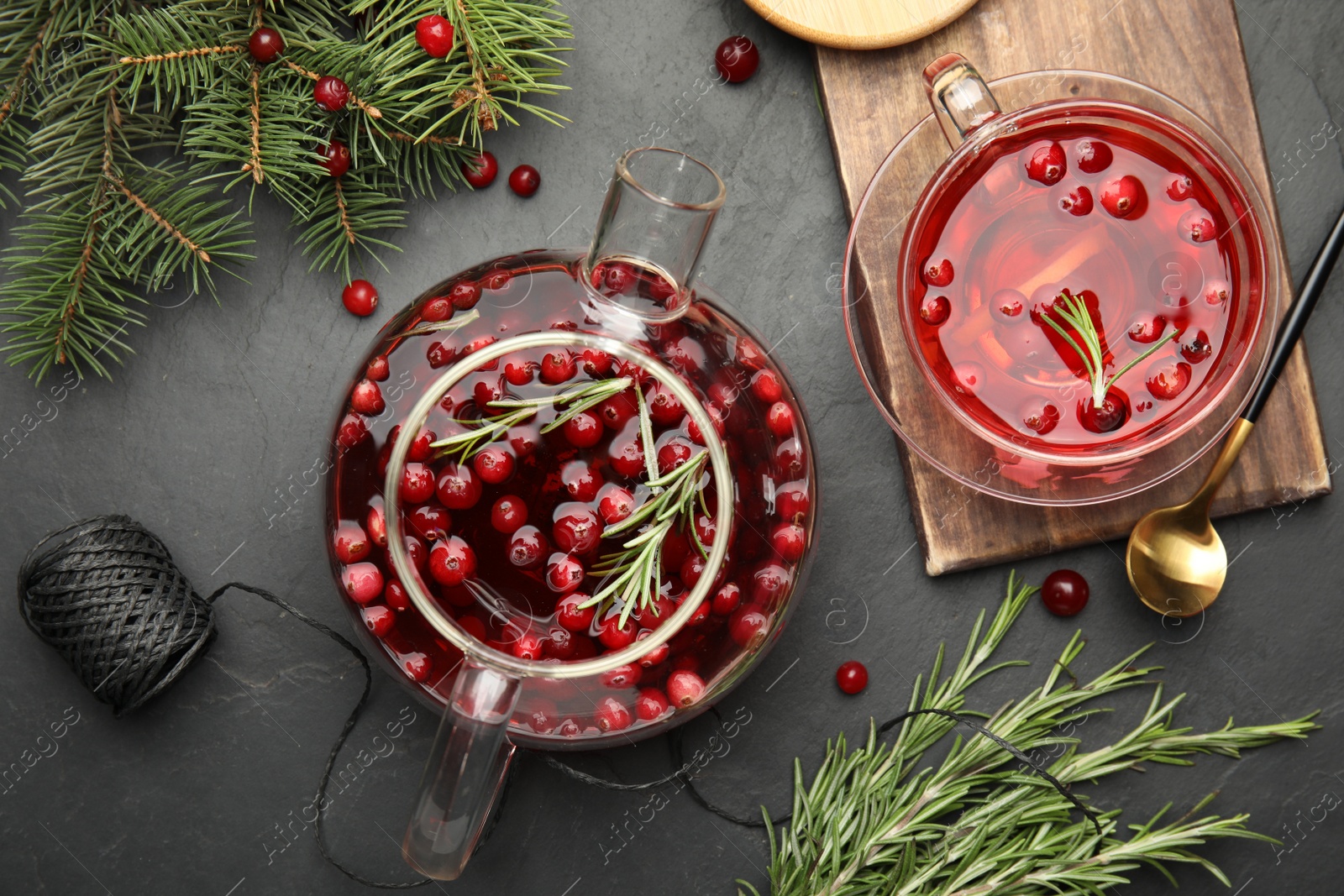 Photo of Flat lay composition with tasty hot cranberry tea on black table