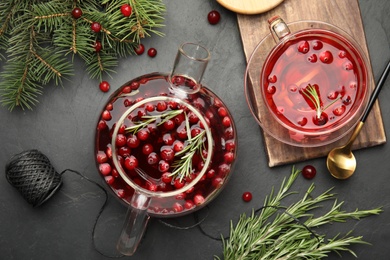 Flat lay composition with tasty hot cranberry tea on black table