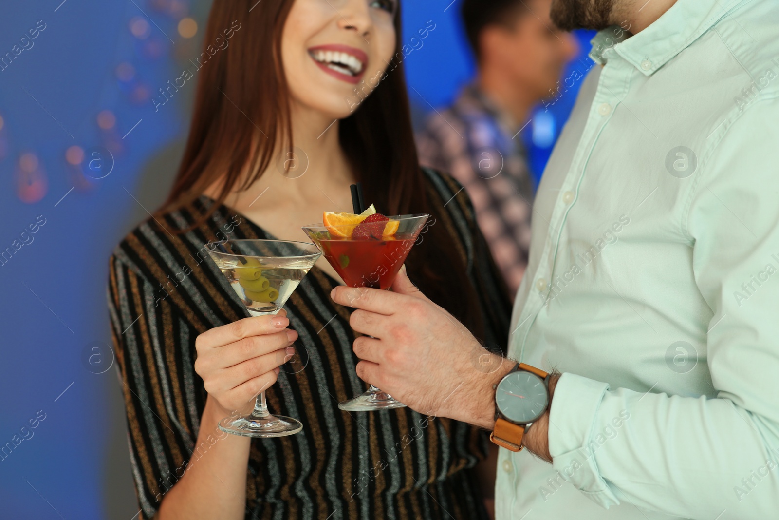 Photo of Young couple with martini cocktails at party, closeup
