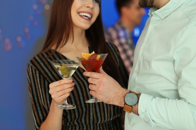 Photo of Young couple with martini cocktails at party, closeup