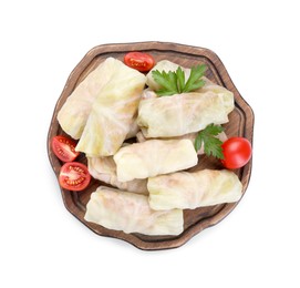 Wooden board with Uncooked stuffed cabbage rolls, tomatoes and parsley isolated on white, top view