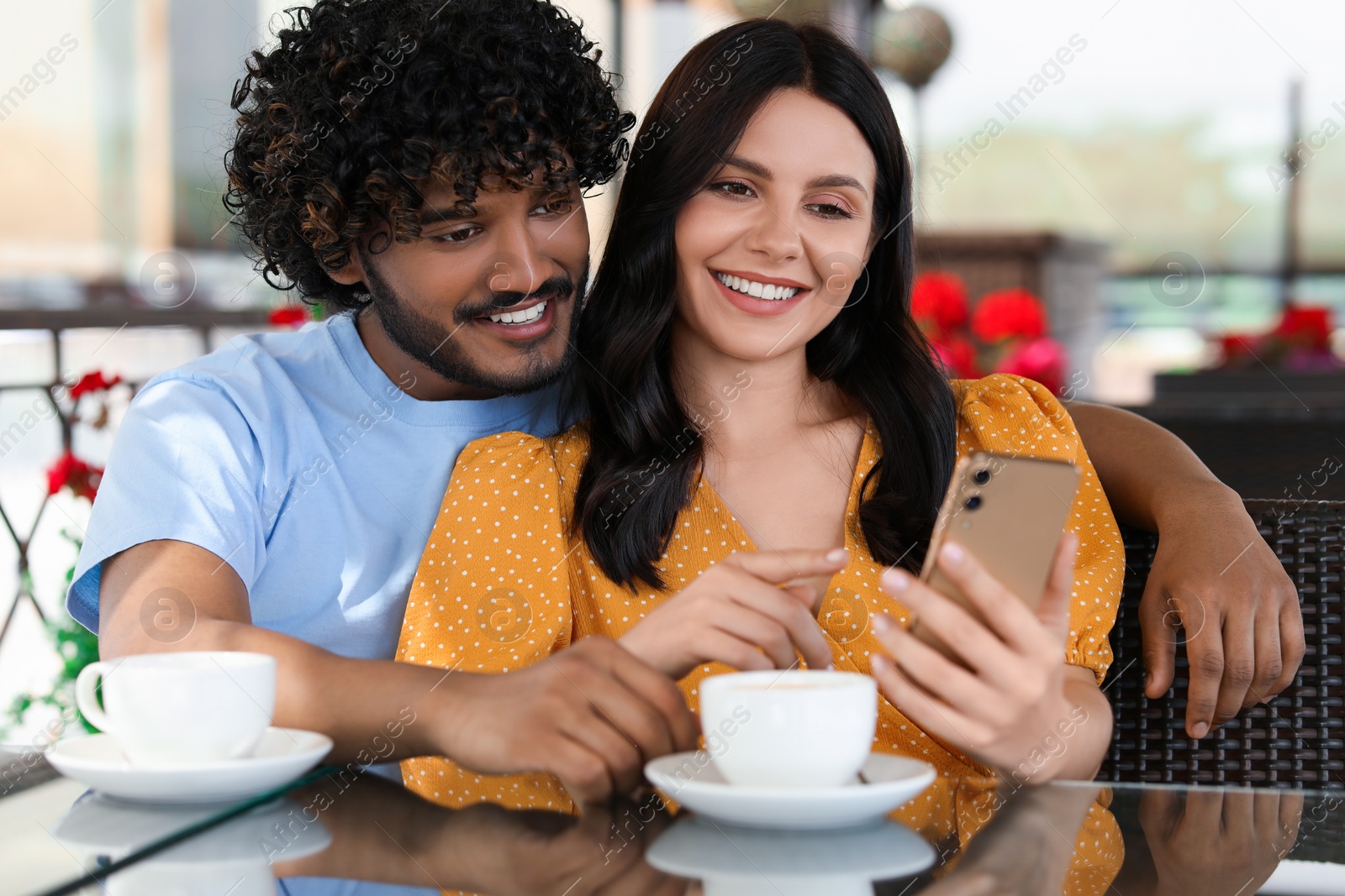 Photo of International dating. Happy couple spending time together in restaurant