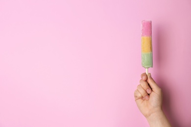 Photo of Woman holding delicious ice cream against color background, space for text