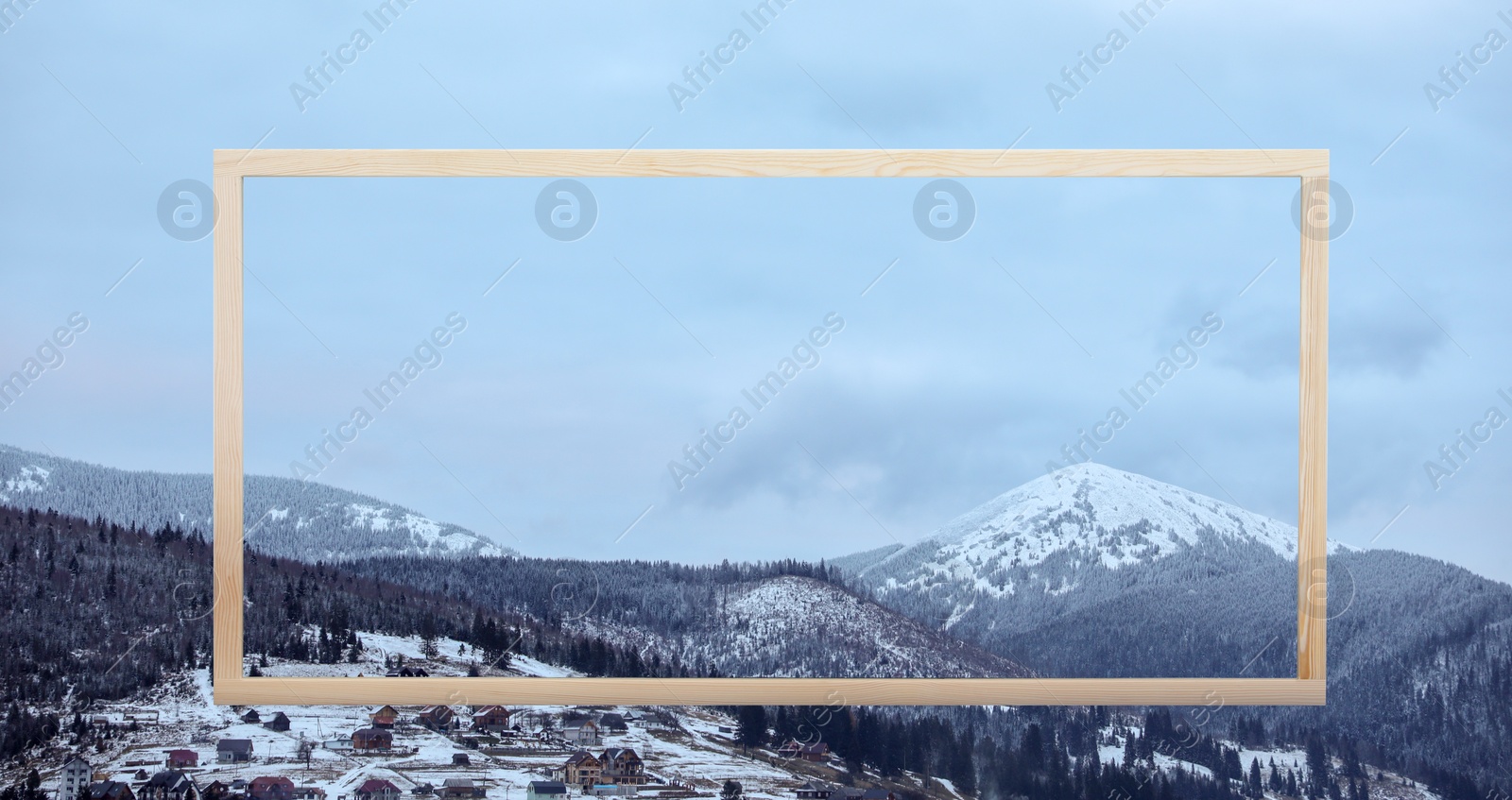 Image of Wooden frame and beautiful mountains covered with snow in winter, banner design