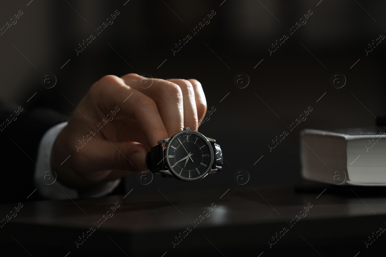 Photo of Man putting luxury wrist watch on table, closeup. Space for text