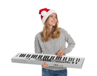 Young woman in Santa hat playing synthesizer on white background. Christmas music