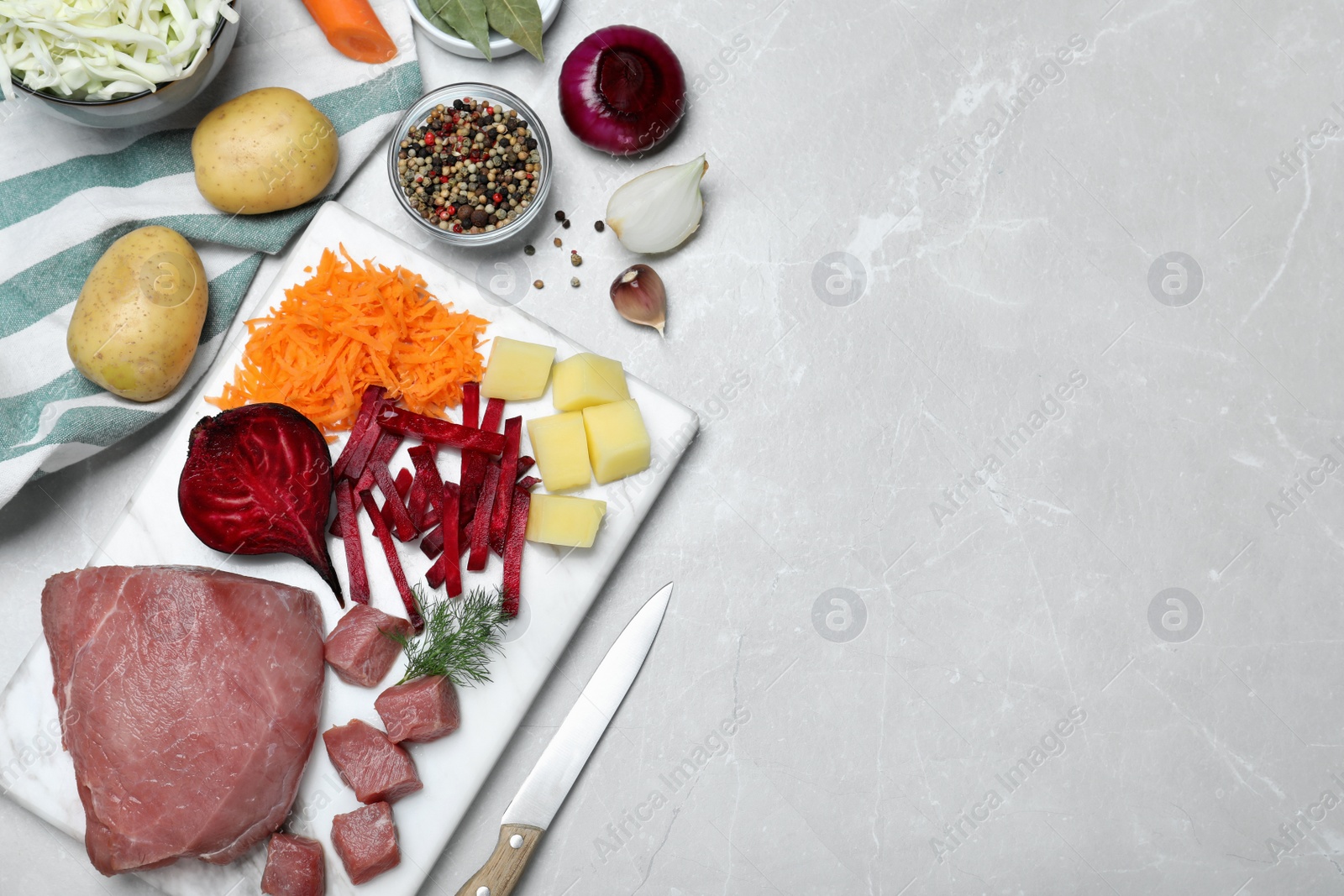 Photo of Fresh borscht ingredients on light grey table, flat lay. Space for text