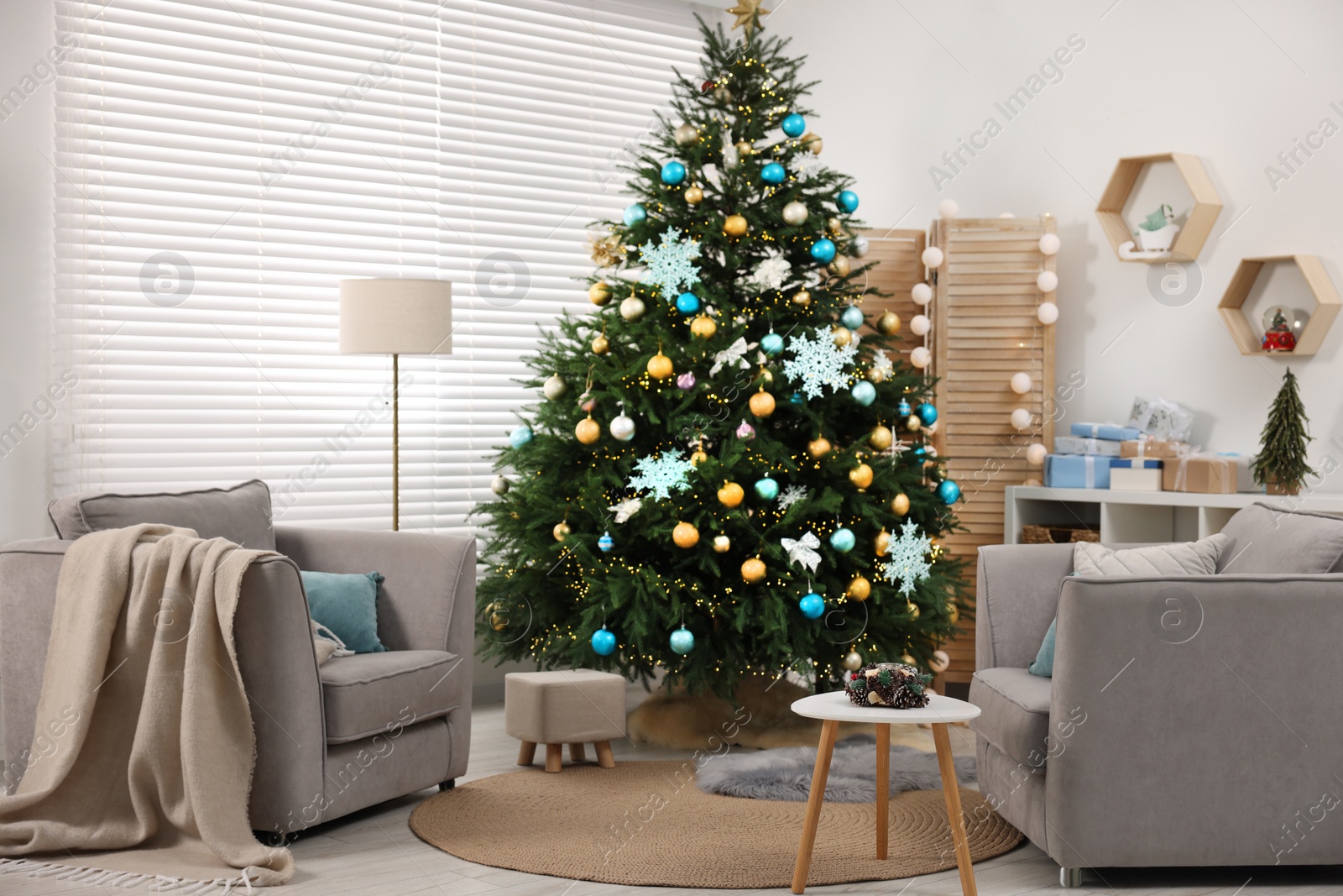 Photo of Christmas tree in room decorated for holiday. Festive interior design