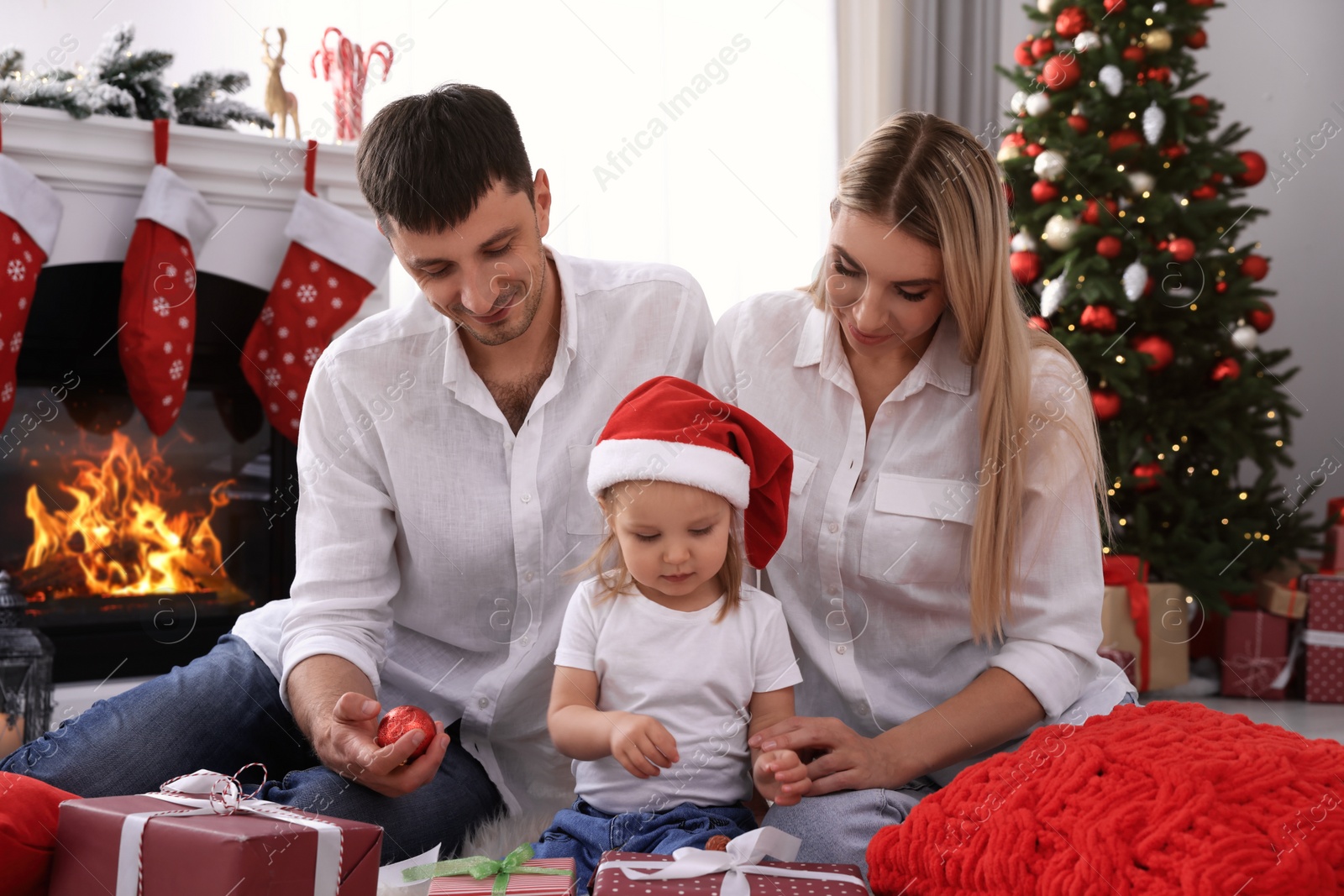 Photo of Happy family with Christmas gifts in festively decorated room