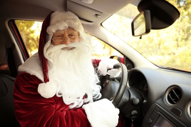 Authentic Santa Claus driving modern car, view from passenger seat