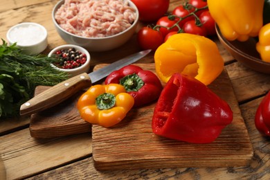 Photo of Making stuffed peppers. Vegetables and ground meat on wooden table