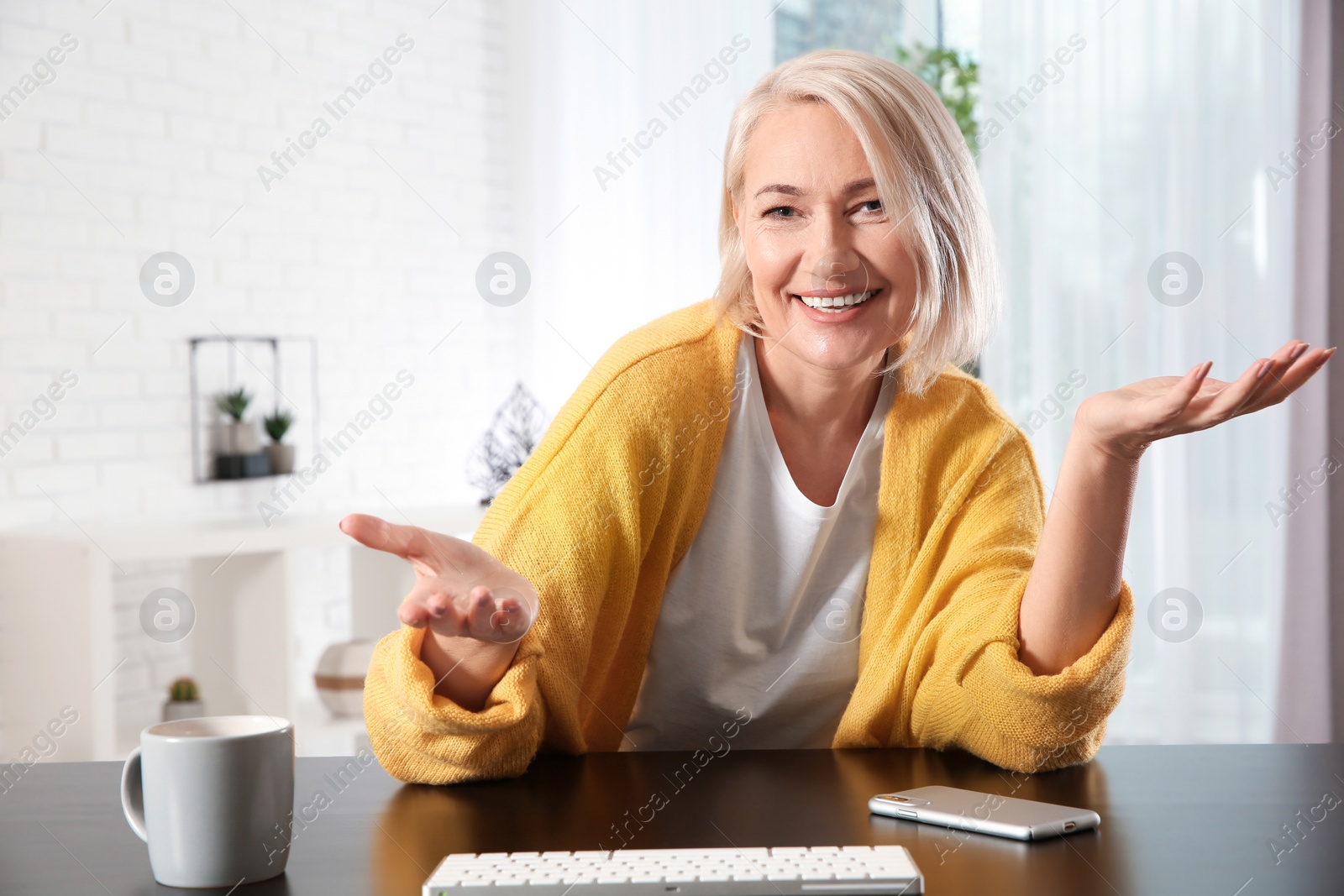 Photo of Mature woman using video chat at home, view from web camera