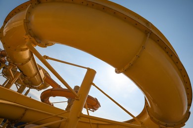 Yellow slide in water park on sunny day