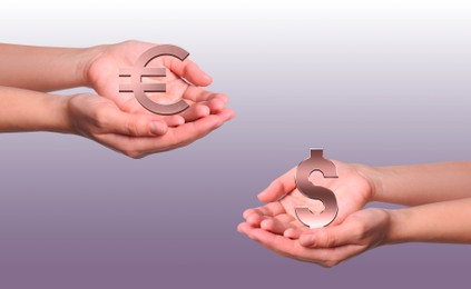 Women demonstrating virtual dollar and euro signs on color background, closeup