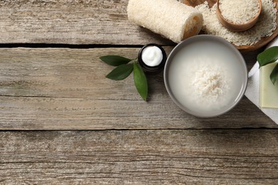 Photo of Flat lay composition with soaked rice on wooden table. Space for text