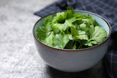 Photo of Fresh green parsley on grey table, closeup